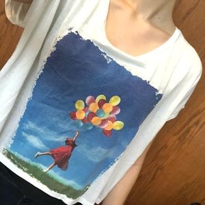 T-shirt with girl holding balloons.